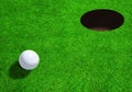 Golf Ball Close to Hole With Copy Space Royalty Free Stock Photo