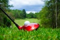 Golf ball and golf club in beautiful golf course at Thailand. Collection of golf equipment resting on green grass with green Royalty Free Stock Photo