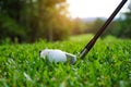 Golf ball and golf club in beautiful golf course at Thailand. Collection of golf equipment resting on green grass with green Royalty Free Stock Photo