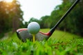 Golf ball and golf club in beautiful golf course at Thailand. Collection of golf equipment resting on green grass with green Royalty Free Stock Photo