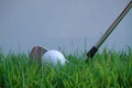 Golf ball and golf club in beautiful golf course at Thailand. Collection of golf equipment resting on green grass with green Royalty Free Stock Photo