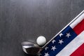 Golf ball and golf club with flag of USA on black table background, sport concept Royalty Free Stock Photo