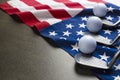 Golf ball and golf club with flag of USA on wood black table background Royalty Free Stock Photo