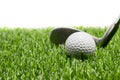 Golf ball and golf club on grass on white background Royalty Free Stock Photo
