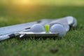 Golf ball and golf club on green grass background Royalty Free Stock Photo