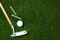 Golf ball, club and tees on artificial grass, top view Royalty Free Stock Photo