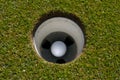 Golf ball in the cup Royalty Free Stock Photo