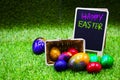 Golf ball with Easter eggs on green grass Royalty Free Stock Photo