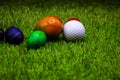 Golf ball with Easter eggs on green grass Royalty Free Stock Photo