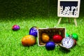 Golf ball with Easter eggs on green grass Royalty Free Stock Photo