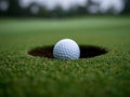 Golf ball on the edge of the golf cup Royalty Free Stock Photo