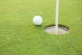 Golf ball at the edge of the hole Royalty Free Stock Photo