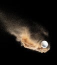 Golf ball explode from sand bunker. Golfer hit ball sand explosion in mid air. Golf club hit ball tee in sand bunker explosion. Royalty Free Stock Photo