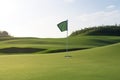 Golf ball and a flag on green hill Royalty Free Stock Photo