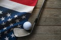 Golf ball with flag of USA on wood table Royalty Free Stock Photo