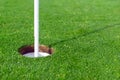 Golf ball and Flagstick of Manicured grass of putting green Royalty Free Stock Photo