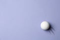 Golf ball flying on lilac background - creative image Royalty Free Stock Photo