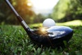 Golf ball and golf club in beautiful golf course with sunset bac Royalty Free Stock Photo