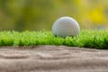 Golf ball on grass close sand bunker