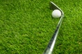 Golf ball and golf club on grass Royalty Free Stock Photo