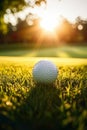 golf ball on a grassy field during a beautiful sunrise. It epitomizes the tranquility of a morning on the golf course