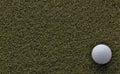Golf ball on green with negative space Royalty Free Stock Photo