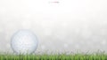 Golf ball on green grass field with light blurred bokeh backgroud. Royalty Free Stock Photo