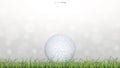 Golf ball on green grass field with light blurred bokeh background. Royalty Free Stock Photo