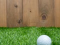 Golf and ball on green grass and wood background