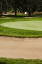 Golf ball on a greenside bunker sand trap hazard in a golf cours Royalty Free Stock Photo