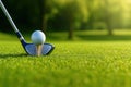 Let`s golf today. Close up of a golf white ball on the green tee and the iron Royalty Free Stock Photo