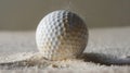 Golf ball hitting the sand in a bunker, with grains of sand flying around, captured in a close-up shot Royalty Free Stock Photo