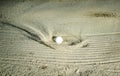 Golf ball hitting the sand bunker Royalty Free Stock Photo