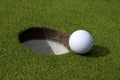 Golf ball and hole Royalty Free Stock Photo