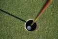 Golf ball is beside the hole Royalty Free Stock Photo