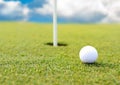 Golf ball at hole on field Royalty Free Stock Photo