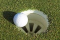 Golf ball and hole on a field Royalty Free Stock Photo
