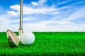 Golf ball and iron on artificial green grass Royalty Free Stock Photo