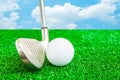 Golf ball and iron on artificial green grass Royalty Free Stock Photo