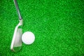 Golf ball and iron on artificial green grass Royalty Free Stock Photo