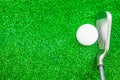 Golf ball and iron on artificial green grass Royalty Free Stock Photo