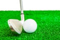 Golf ball and iron on artificial green grass Royalty Free Stock Photo