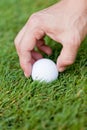 Golf ball and iron on green grass detail macro Royalty Free Stock Photo