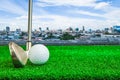 Golf ball, iron and tee on artificial green grass Royalty Free Stock Photo