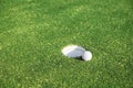 Golf ball on lip of cup Royalty Free Stock Photo