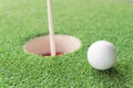 Golf ball on lip of cup Royalty Free Stock Photo