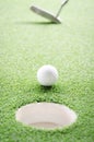 Golf ball on lip of cup Royalty Free Stock Photo