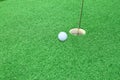 Golf ball on lip of cup