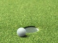 Golf ball on lip of cup of lovely beautiful golf course Royalty Free Stock Photo