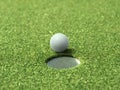 Golf ball on lip of cup of lovely beautiful golf course Royalty Free Stock Photo